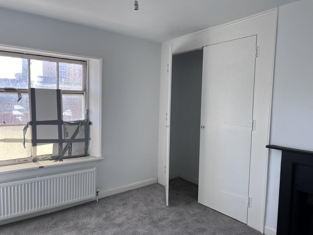 Lot: 145 - THREE-BEDROOM MAISONETTE - Bedroom with storage cupboard